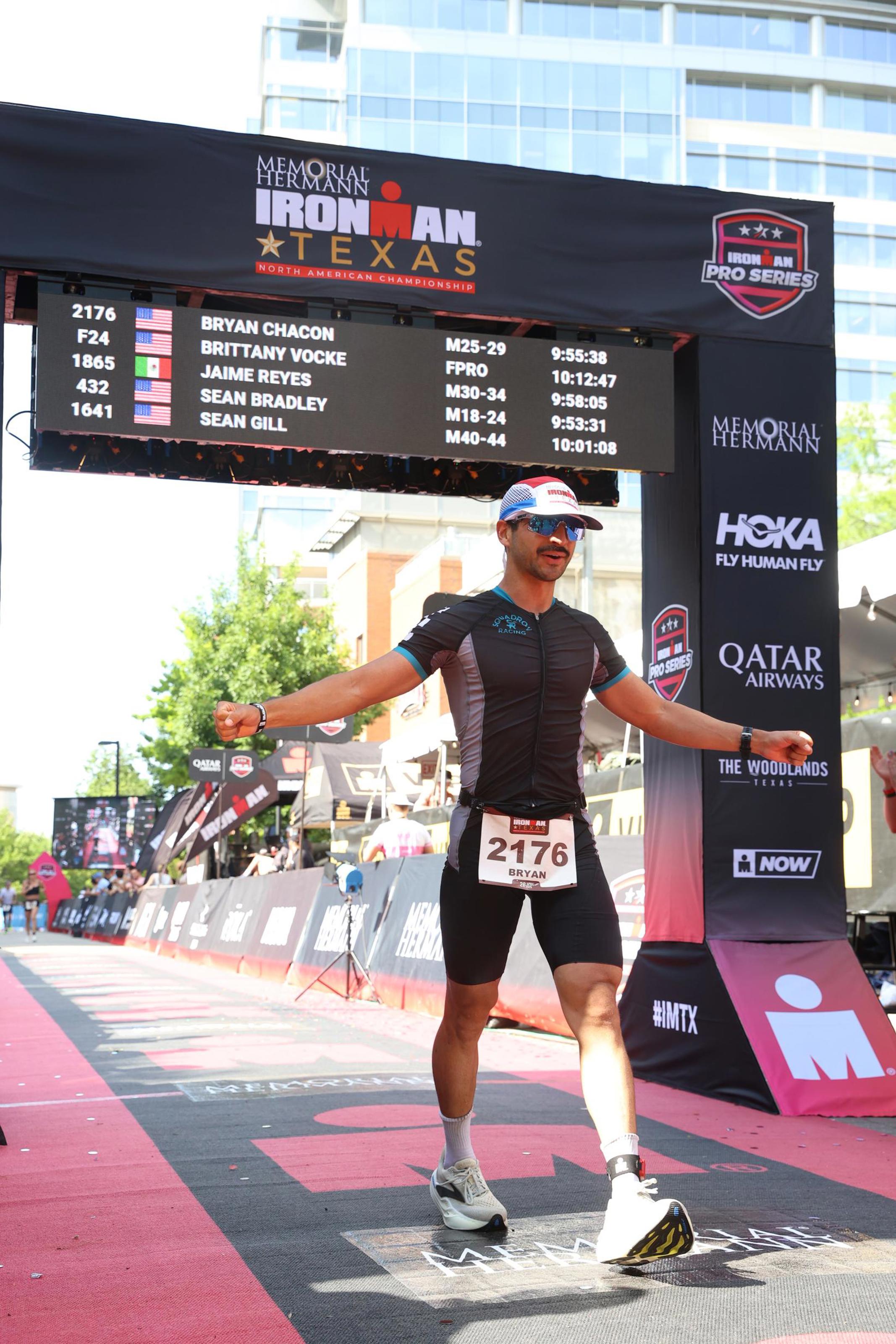 Triathlete crossing the finish line at Ironman Texas triathlon.