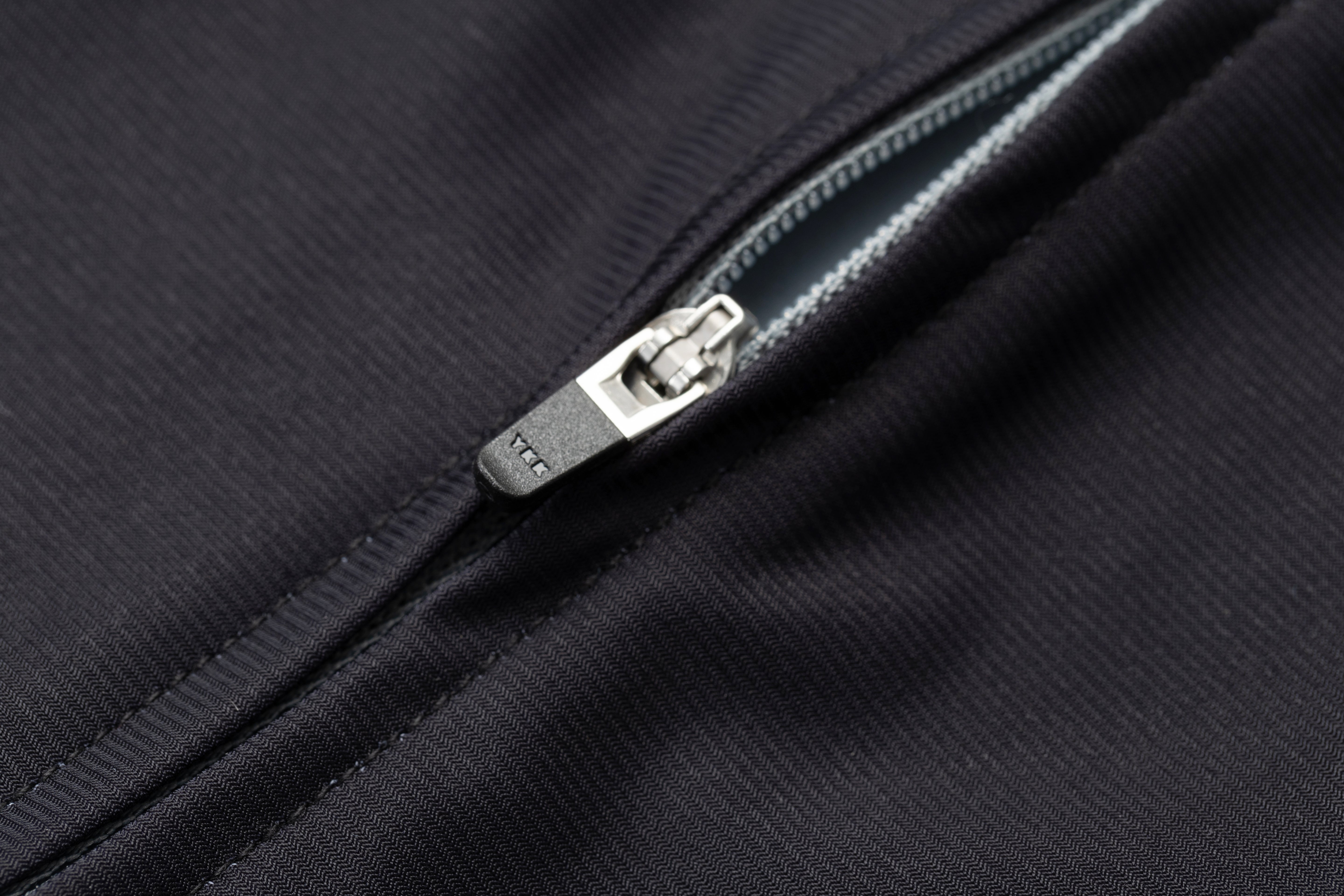 Macro view of front zipper on black TSR women's triathlon suit