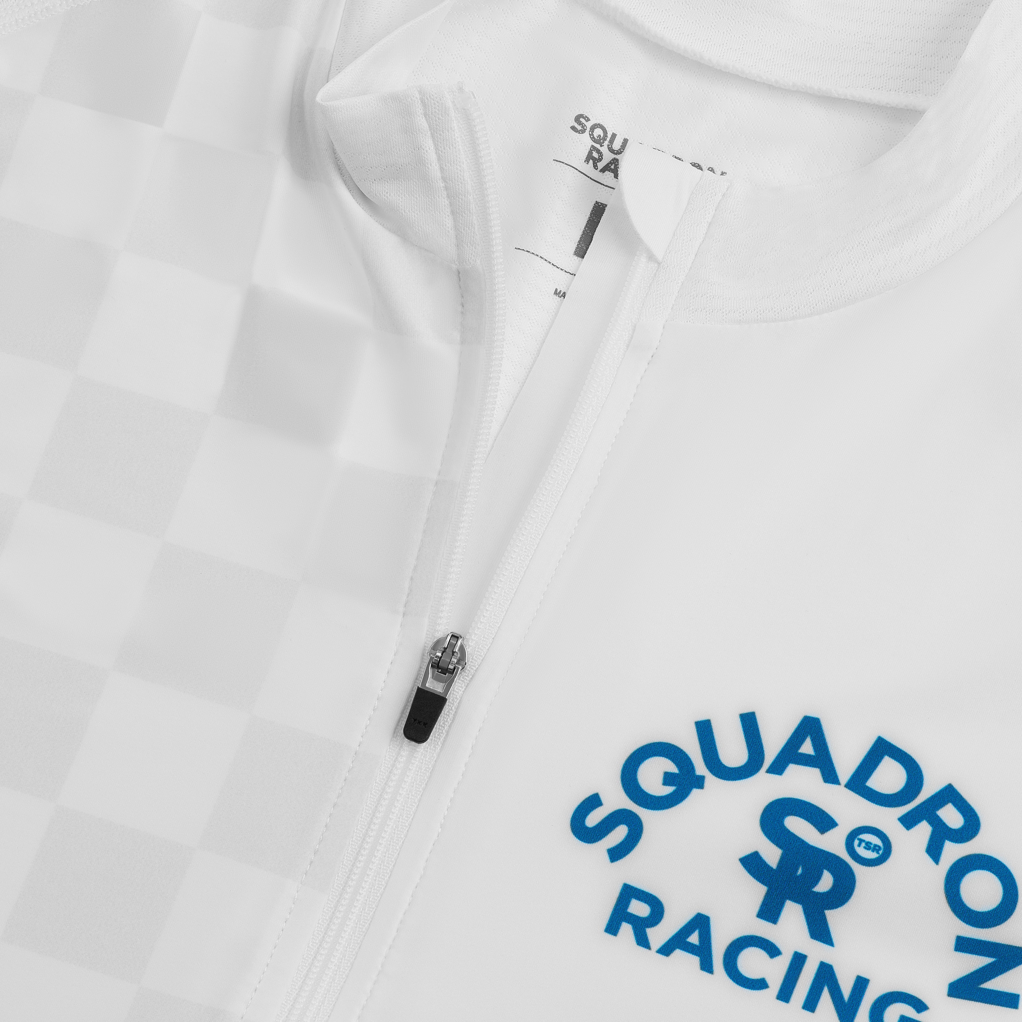 Close-up of white race jersey showing Squadron Racing logo and front zipper detail.