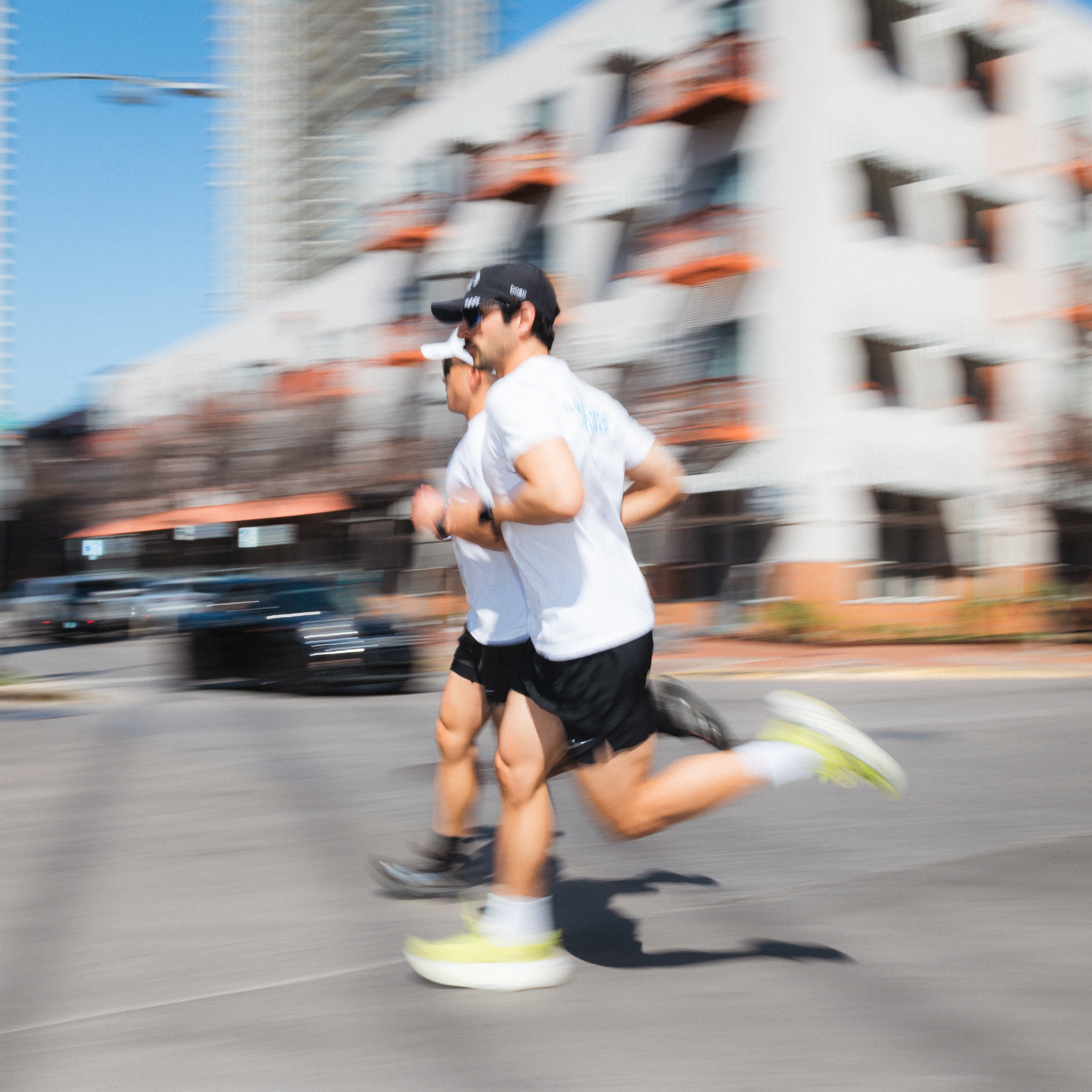 Two Squadron Racing Athletes running through downtown Austin. 