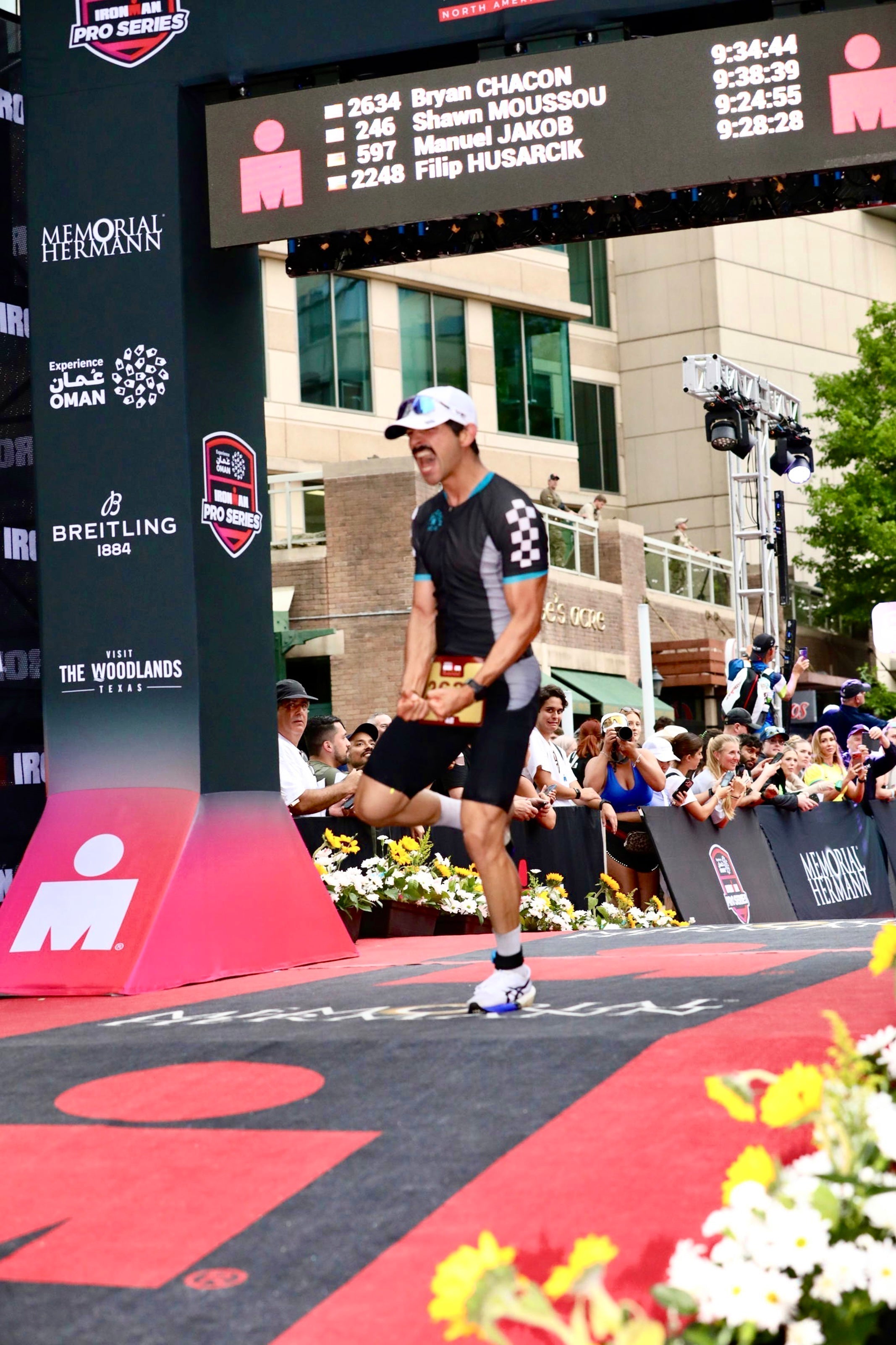 Squadron Racing Athlete crossing the ironman Texas finish line.