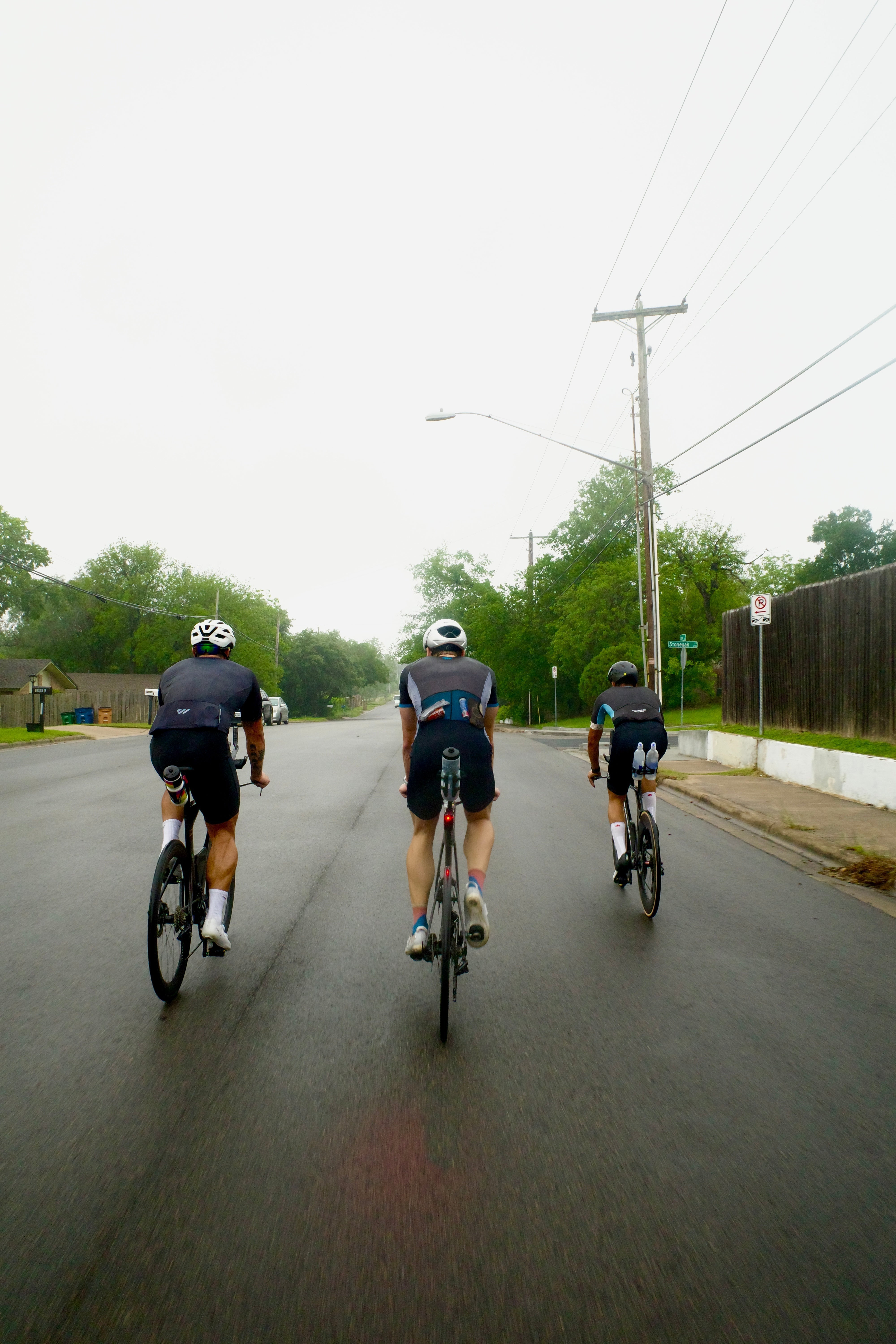 Squadron Racing athletes cycling through a rainy segment out of Austin Texas.