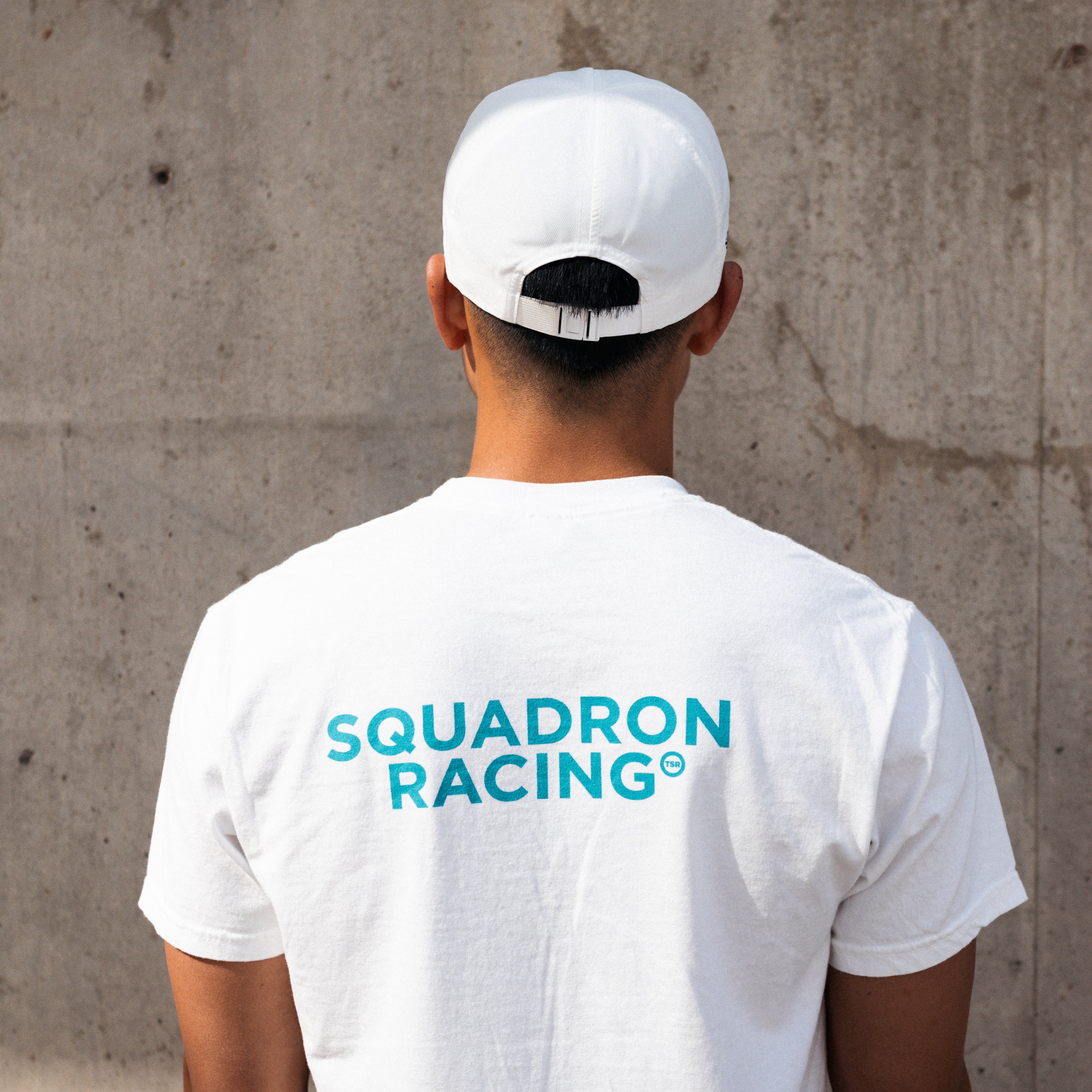 Athlete wearing a squadron racing white hat, facing away. 
