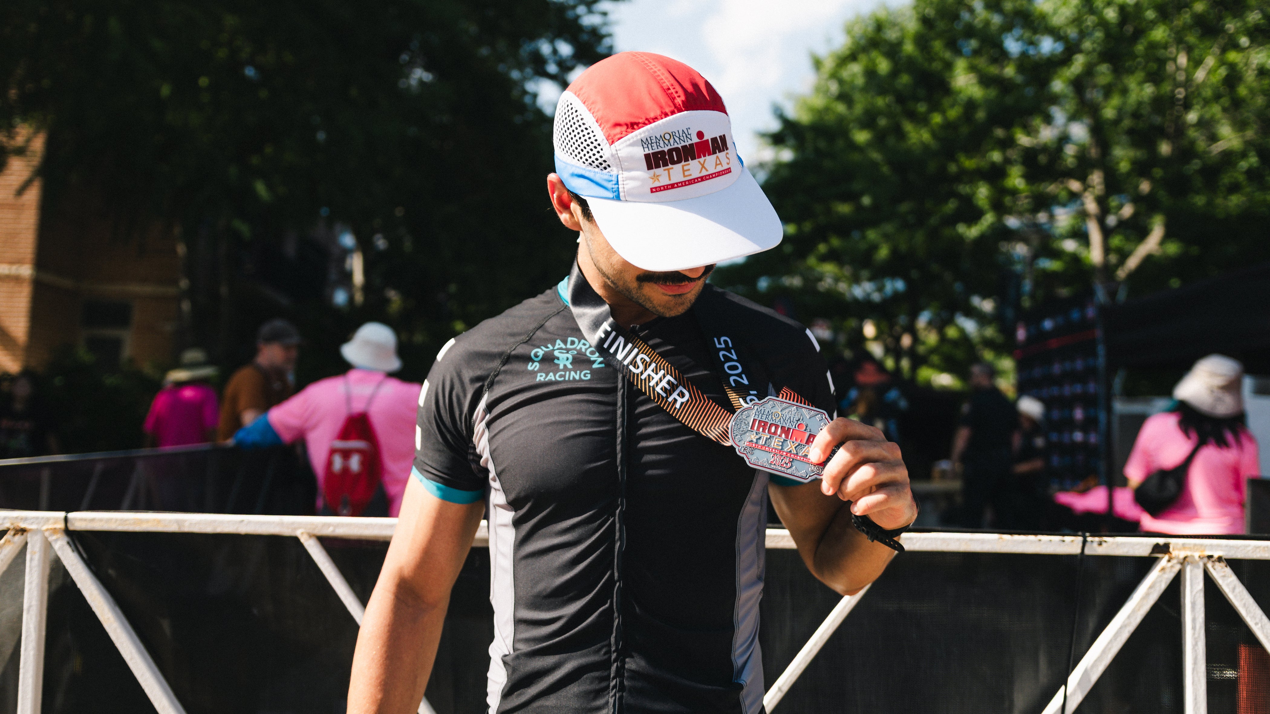 Squadron Racing Triathlete in triathlon race suit with an ironman triathlon medal.